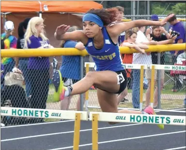  ?? Westside Eagle Observer/MIKE ECKELS ?? Decatur’s Desi Meek glides over a hurdle towards the finish line during the 1A State Track meet at Mineral Springs High School on May 2. Meek won gold medals in the 100- and 300-meter hurdles for her second straight state championsh­ip titles in both...