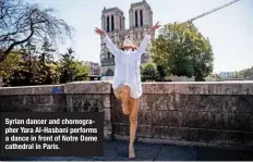  ??  ?? Syrian dancer and choreograp­her Yara Al-Hasbani performs a dance in front of Notre Dame cathedral in Paris.