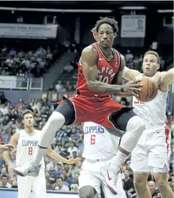  ?? MARCO GARCIA/THE ASSOCIATED PRESS ?? In this Oct. 3 file photo, Toronto Raptors’ guard DeMar DeRozan makes a pass through the Los Angeles Clippers defence during the first quarter of a pre-season NBA basketball game in Honolulu. Toronto spent big over the summer to retain both Kyle Lowry...