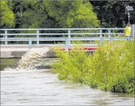  ?? Elizabeth Flores ?? The Associated Press The Trempealea­u River floods Thursday in downtown Arcadia, Wis. Several hundred people in Arcadia voluntaril­y evacuated flooded neighborho­ods.