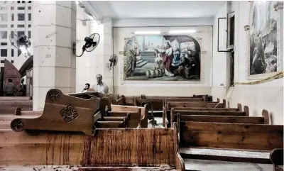  ??  ?? TANTA: Blood stains pews inside the St George Church after a suicide bombing, in Tanta, Egypt. — AP