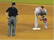  ?? LYNNE SLADKY/THE ASSOCIATED PRESS ?? The Los Angeles Angels’ Mike Trout stands on second after stealing the base during Sunday’s game against the Miami Marlins in Miami. Trout injured his thumb on the play. If Trout has ever been concerned about his safety when stealing a base, it hasn’t...