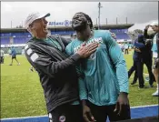  ?? TIM IRELAND / AP ?? Running back Jay Ajayi (right) relaxes after one of the Dolphins’ practices at Allianz Park in London. Ajayi and his teammates will have plenty of fans Sunday at Wembley Stadium when they face the Saints.