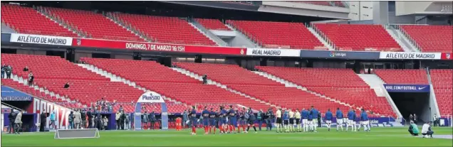  ??  ?? Atlético y Real Madrid forman en el inicio del partido en un Wanda Metropolit­ano sin público en las gradas. Un derbi muy atípico sin público.