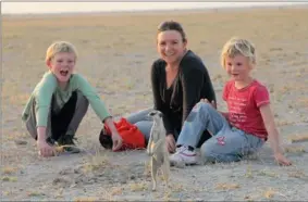  ??  ?? MEERKAT MANOEUVRES: Kit, 8, Jane and Tess, 6, are entertaine­d by a meerkat.