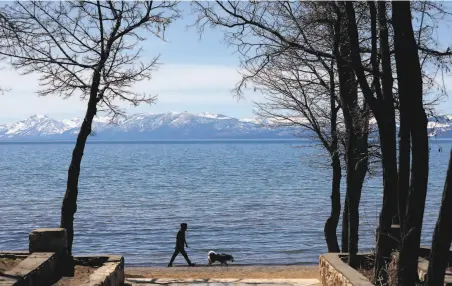  ?? Michael Macor / Special to the Chronicle ?? Most activities that lend themselves to social distancing are allowed, such as walking at Kings Beach State Park in Placer County.