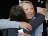  ?? (AP Photo/Danny Johnston File) ?? In this Oct. 22, 2013 file photo, Mount St. Mary school teacher then, Tippi McCullough, right, is hugged by a supporter after a Little Rock, Ark. The Catholic school teacher was allegedly told she would be fired from her job after she married her wife in New Mexico. A longtime abortion opponent who once opposed allowing gay couples to be foster parents, Arkansas Gov. Asa Hutchinson is the unlikelies­t figure to complain about bills on the “culture wars” reaching his desk.