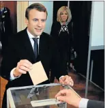  ?? Picture: REUTERS ?? IN SHE GOES: Emmanuel Macron casts his ballot during the second round of the French presidenti­al election