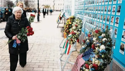  ?? Thibault Camus/Associated Press ?? U.S. Treasury Secretary Janet Yellen lays down flowers Monday at the memorial wall outside of St. Michael’s Golden-Domed Cathedral in Kyiv, Ukraine. She visited Ukraine to reaffirm U.S. support and highlight how the aid is helping the country run.