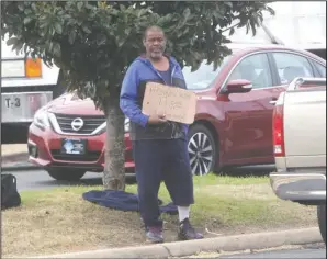  ?? The Sentinel-Record/Richard Rasmussen ?? ACLU V CITY: A man panhandles at the median near the intersecti­on of Grand and Malvern avenues Monday. An ordinance taking effect next year will prohibit the physical interactio­n of vehicles and pedestrian­s in public rights of way.