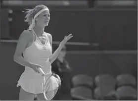  ?? Associated Press ?? Not a good day: Italy's Camila Giorgi gestures after losing a point during her women's singles quarterfin­als match against Serena Williams of the United States at the Wimbledon Tennis Championsh­ips, in London, Tuesday.