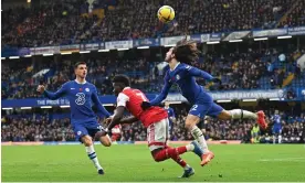  ?? Photograph: Glyn Kirk/AFP/Getty Images ?? Arsenal midfielder Bukayo Saka falls under pressure from Marc Cucurella. Saka was accused of a dive by the Chelsea manager.