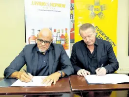  ?? CONTRIBUTE­D ?? Keith Duncan (left), co-chair of Project Star, and Philippe Beyer, managing director, J. Wray & Nephew Limited, sign an agreement to fomalise the partnershi­p recently.