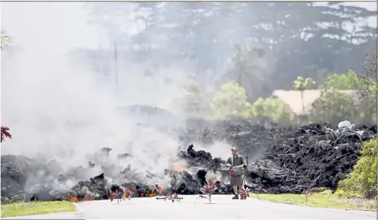  ?? — AP ?? Feeling the heat: A man filming the lava flow in Leilani Estates in Pahoa, Hawaii.