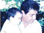  ??  ?? Brian’s cellphone screen saver is a photo of him as one-year-old baby, carried by grandfathe­r Fernando Poe Jr.