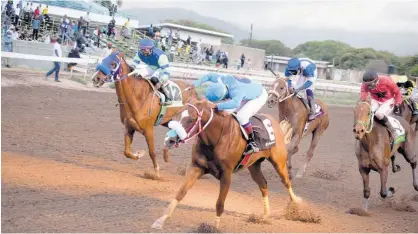  ?? FILE ?? RUNAWAY ALGO (front right), ridden by Christophe­r Mamdeen, wins the Easter Sprint Cup over 1,100 metres at Caymanas Park in April.
