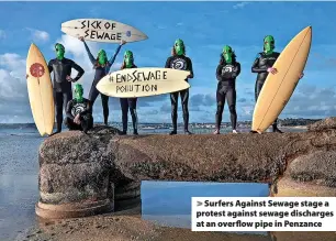  ?? Emily Whitfield-Wicks ?? > Surfers Against Sewage stage a protest against sewage discharges at an overflow pipe in Penzance