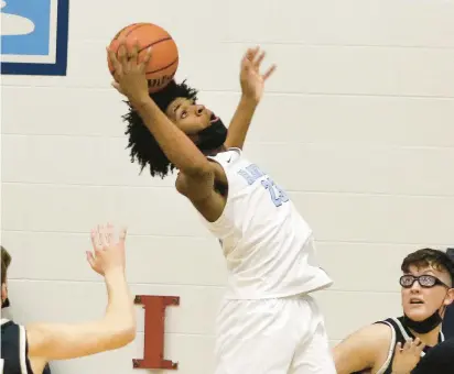  ?? JOHN SMIERCIAK/DAILY SOUTHTOWN PHOTOS ?? Hillcrest’s Marcus Glover rebounds against Oak Forest during a South Suburban Blue game on Friday.