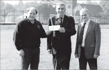  ?? 01_B42twe02 ?? Ian Small and Tommy Gilmore of the Arran Sports Associatio­n receive a cheque for £5,000 from Stuart Montgomery of Scottish Brewers. This donation almost completes the total necessary for the whole project which is nearly now complete.