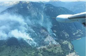  ??  ?? Eighty firefighte­rs and six helicopter­s are on scene to fight the fire that is near the eastern side of Harrison Lake.