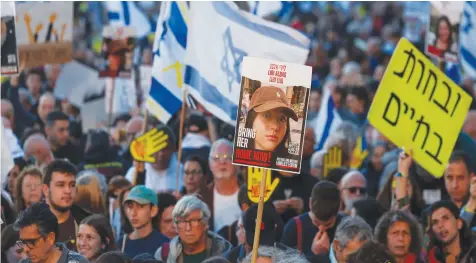  ?? (Ronen Zvulun/Reuters) ?? ISRAELIS RALLY for the immediate release of the hostages near the Knesset in Jerusalem yesterday, exactly six months after they were kidnapped to Gaza on October 7. A photo of Liri Albag is held up in the center.