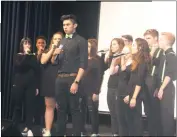  ??  ?? La Plata High School sophomore Edwin Santos, center, and members of the school’s a cappella group Unplugged rehearse in preparatio­n for Saturday’s a cappella regional competitio­n at the school.