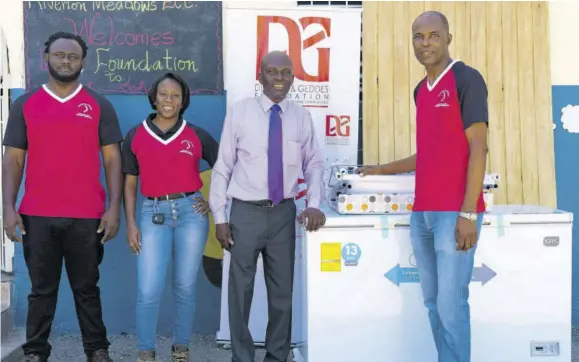  ?? ?? Riverton Meadows Early Childhood Centre Principal Junior Rowe (second right) is pleased to receive a new refrigerat­or and other supplies from D&G Foundation accountant Dennis Beckford (right) and his foundation volunteers Andre Hamilton and Lori-ann Vincent during a recent visit to the institutio­n.