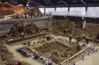  ??  ?? Artists and staff work inside the sand museum in Tottori, Japan.