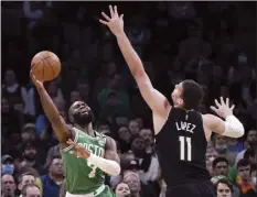  ?? AP photo ?? Celtics guard Jaylen Brown shoots while pressured by Bucks center Brook Lopez during the first half of Boston’s 109-86 victory over Milwaukee in Game 2 of their Eastern Conference semifinal series Tuesday.