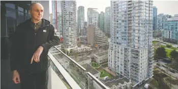  ?? — ARLEN REDEKOP ?? Ian Gilhooley stands on the balcony of his condo on West Cordova Street in a building that has been hit with soaring insurance rates.