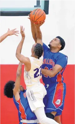  ?? GREG SORBER/JOURNAL ?? Las Cruces’ R.J. Brown, right, blocks the shot of Clovis’ Jakeem Wynn during the first round of play in the Joe Armijo Classic.