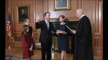  ?? THE ASSOCIATED PRESS ?? As newly-confirmed Judge Brett Kavanaugh arrives at the Supreme Court to be sworn in as an associate justice, he was met by hundreds of protesters demonstrat­ing on the steps of the building. (Oct. 6)