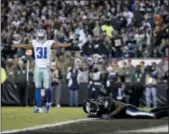  ?? MATT SLOCUM — THE ASSOCIATED PRESS ?? Eagles wide receiver Alshon Jeffery, right, lies on the ground after missing a catch as Cowboys cornerback Byron Jones reacts during the second half Sunday