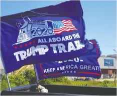 ?? THOMAS WERNER / BLOOMBERG ?? Donald Trump 2020 campaign flags fly in Wisconsin but the U.S.
president has had little to say about his second-term strategy.