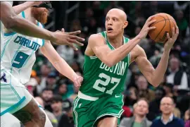  ?? MICHAEL DWYER — THE ASSOCIATED PRESS ?? Boston Celtics’ Jordan Walsh (27) looks to pass against Charlotte Hornets’ Davis Bertans (9) during the second half of an NBA basketball game, Friday, April 12, 2024, in Boston.