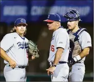  ?? John Hefti / Associated Press ?? UConn coach Jim Penders, middle talks to pitcher Devin Kirby, left, and catcher Matt Donlan, right, during the ninth inning of Saturday’s win at Stanford.