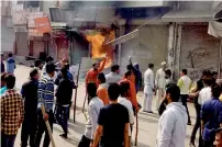  ?? PTI ?? Protesters set shops on fire in Sonepat. —