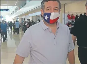  ?? (AP/Dan Christian Rojas) ?? Sen. Ted Cruz, R-Texas, walks to check in Thursday for his flight back to the U.S. at Cancun Internatio­nal Airport in Cancun, Mexico. On Friday, The Associated Press reported on stories circulatin­g online incorrectl­y asserting in 2016, Cruz tweeted, “I’ll believe in climate change when Texas freezes over.” The tweet is fabricated.