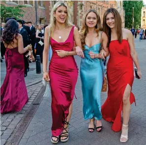  ?? ?? Summer celebratio­ns: Revellers at the Trinity May Ball on Monday evening and, right, others make their way home early yesterday