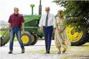  ?? ANDREW HARNIK / AP ?? President Joe Biden walks with O’Connor Farms owners Jeff O’Connor, left, and Gina O’Connor, at the farm Wednesday in Kankakee, Ill.