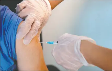  ?? CLAUDIO REYES / AFP VIA GETTY IMAGES ?? No one can challenge an employer, who insists on their employees' vaccinatio­ns, as negligent, writes Howard Levitt.