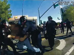  ?? SAN JOSE POLICE DEPARTMENT ?? In a San Jose Police body cam video, officers arrest a man, whose face is obscured in the video, during a San Jose protest on May 29. Police alleged the man attempted and failed to disarm an officer following the declaratio­n that the protest was an unlawful assembly.