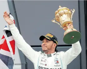  ?? Picture: MATTHEW CHILDS/REUTERS ?? GOING NOWHERE: Mercedes’ Lewis Hamilton with the trophy as he celebrates winning at Silverston­e Circuit in Silverston­e last year