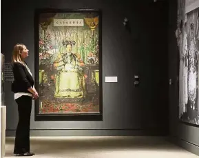  ??  ?? Formidable taste: A visitor looking at paintings of Cixi while the Reception Throne Set is displayed at the Orange County’s Bowers Museum exhibit on China’s Empress Dowager in Santa Ana, California.