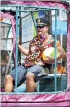  ?? PETER HVIZDAK - NEW HAVEN REGISTER ?? Branford Police Lt. Patrick James O’Malley clowns with the crowd as he waits to drop in a water tank triggered by a well aimed softball, during a Dunk-A-Cop fundraisin­g event on the Branford Green.