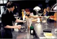  ?? NWA Media/ANDY SHUPE ?? Bartenders fill orders Jan. 17 during a comedy show at the UARK Bowl in Fayettevil­le.