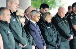 ?? Yui Mok ?? > Mayor of London Sadiq Khan joins London Ambulance workers in observing a minute’s silence at London Ambulance Service HQ at Waterloo