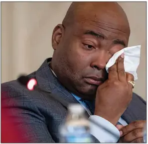  ?? (AP/Nathan Howard) ?? Democratic National Committee Chairman Jaime Harrison wipes a tear Friday at a DNC meeting in Washington as committee member Donna Brazile contended the party has for years failed Black voters. “That’s what this is about,” she said.