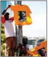  ?? AP ?? Supporters hold up T-shirts of South African Deputy President and African National Congress party President Cyril Ramaphosa on Sunday in Cape Town, South Africa.