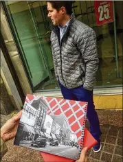  ?? BILL TORPY / AJC ?? Jake Nawrocki, president of Newport US, stands on what Peachtree Street is and with a photo of what it was.